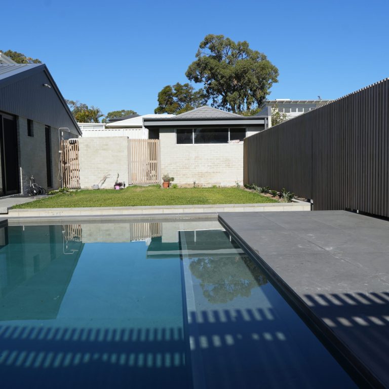 Swimming pool, lawn and rear of the home at the Gwelup renovation by Skytree Homes