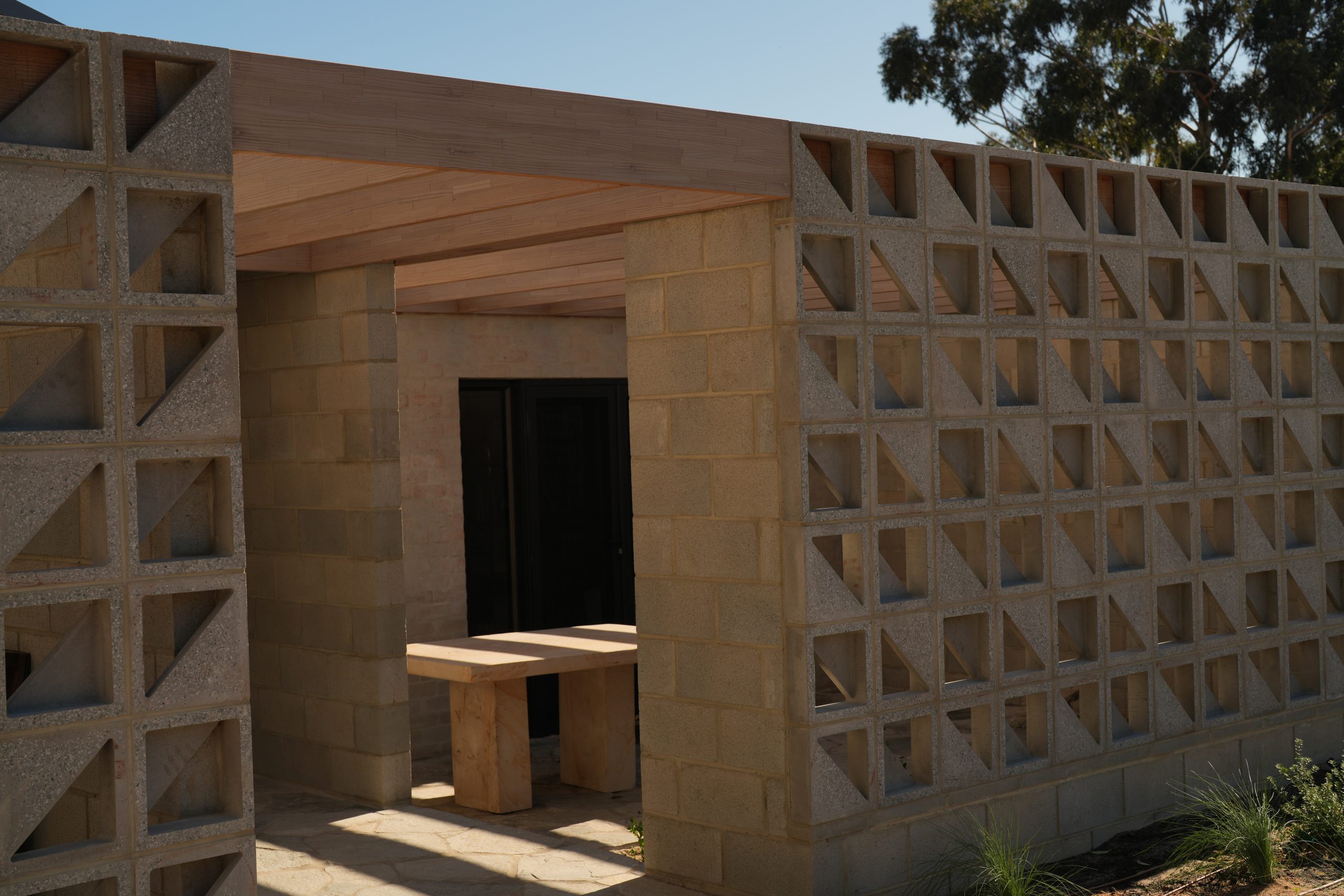 Outdoor structure with breeze-block screen walls at the Gwelup renovation by Skytree Homes